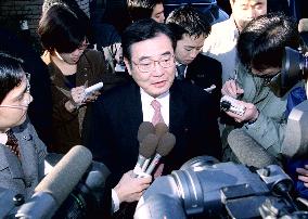 LDP's Kato surrounded by reporters out front of his home